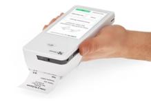 Photo showing a portable handheld Clover device printing a customer receipt