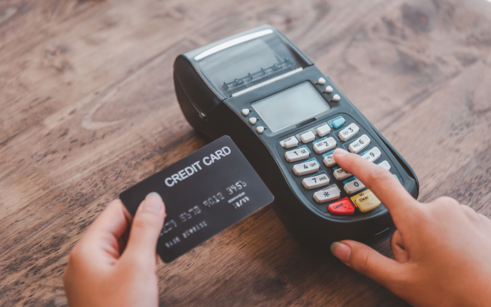 Close up. Paying with credit card and entering card number to terminal