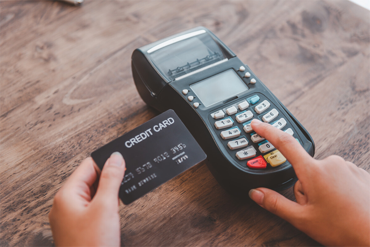 Paying with a credit card. Entering credit card info into payment terminal.