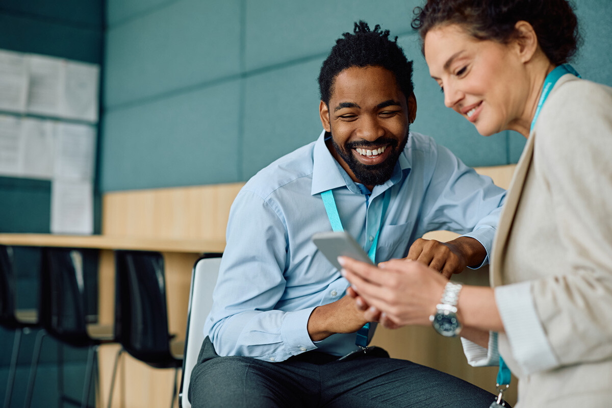 A male and a female union workers, checking out LinkedUnion new app