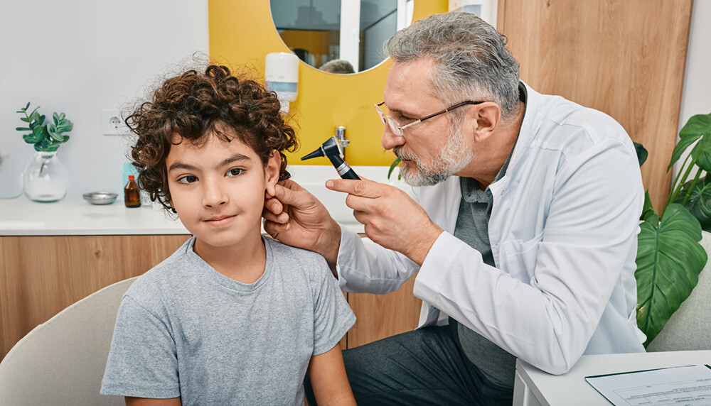 Hearing and Speech doctor, checking child's ear