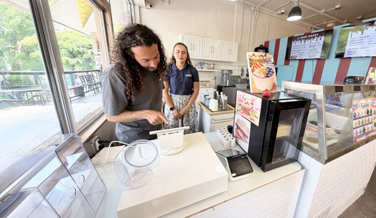 Maddie, David, our reps in Hawaii installing a terminal at an ice cream merchant
